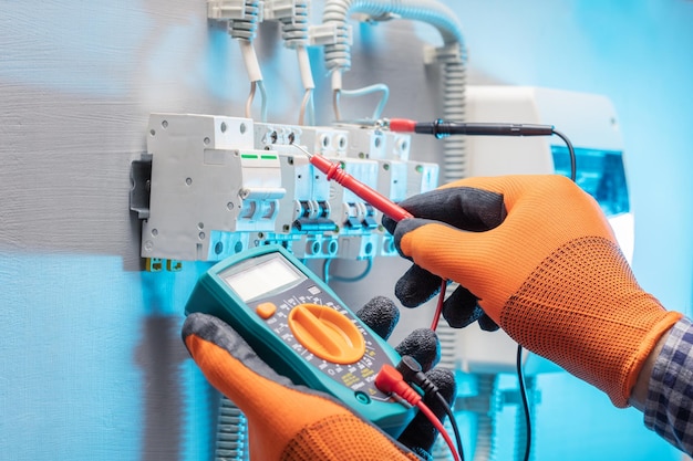 Electrician work tester measuring voltage in fuse board\
electrical engineering concept selective focus