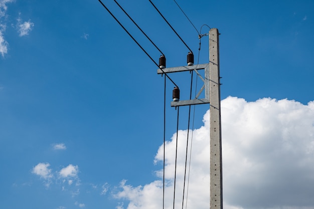 Electricity concrete post and high voltage wire at blue sky background