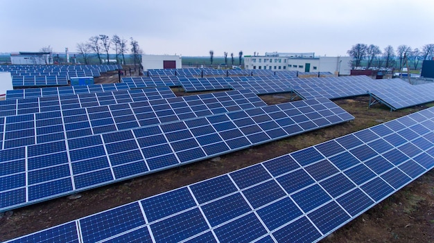 Electricity generation from solar panels on a cloudy day Houses and trees behind the site of solar cells