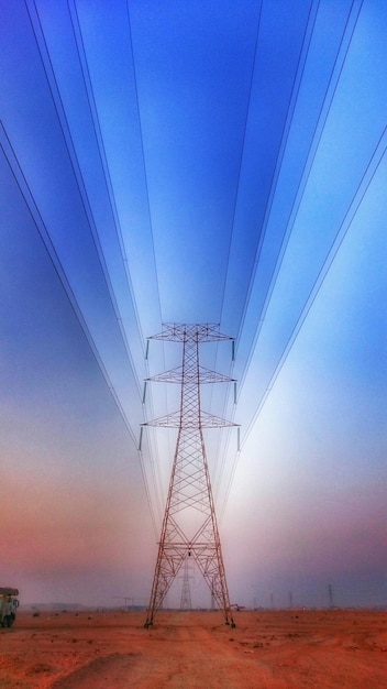 Electricity pylon against blue sky