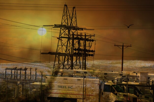 Electricity pylon against sky during sunset