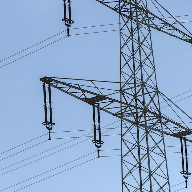 Electricity pylon on blue cloudy sky industry high voltage