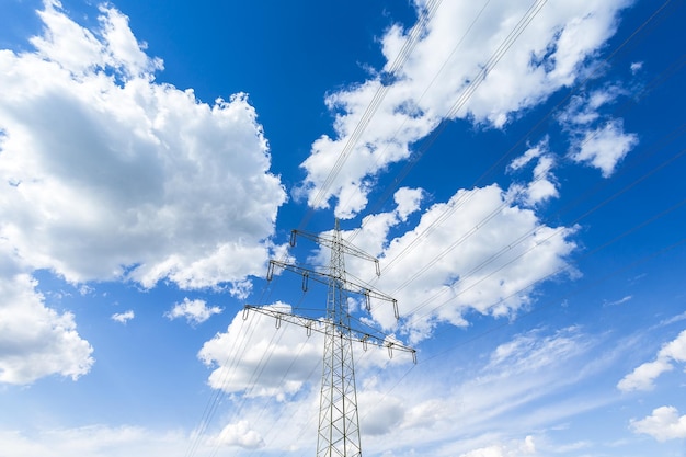 Electricity pylon on blue cloudy sky industry high voltage