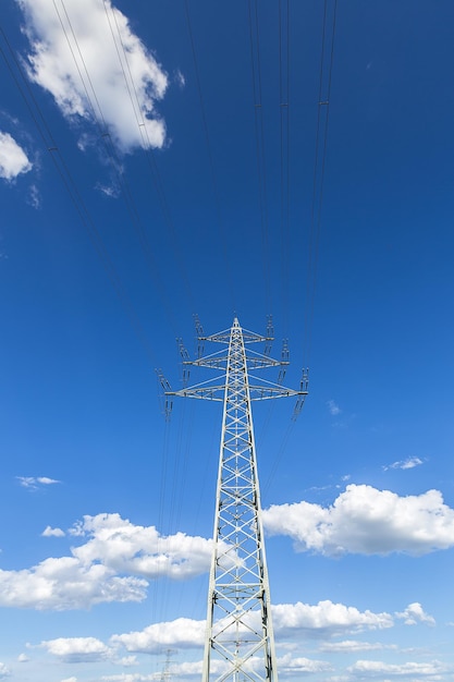 Electricity pylon on blue cloudy sky industry high voltage