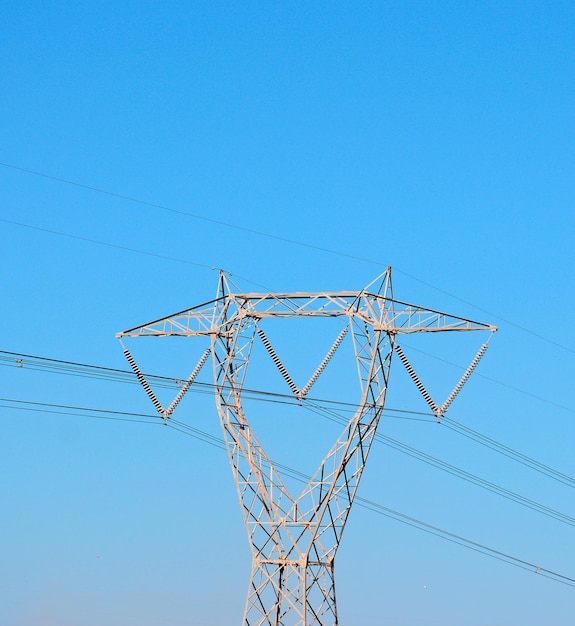 Electricity pylon under a blue sky