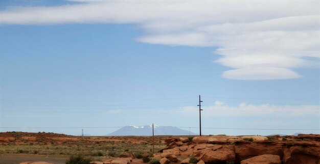 Electricity pylon on land against sky