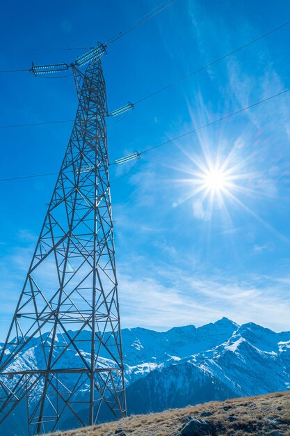 Electricity pylons in a mountain place origin transport and need for electricity eletricity grid