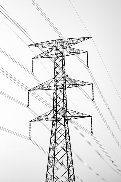 Electricity transmission tower under the foggy sky in the early winter morning