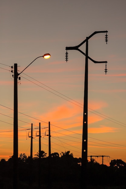 オレンジ色の夕焼け空を背景にした電化投稿。