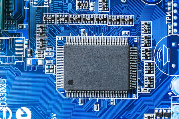 Electronic chip and SMD components on blue circuit board