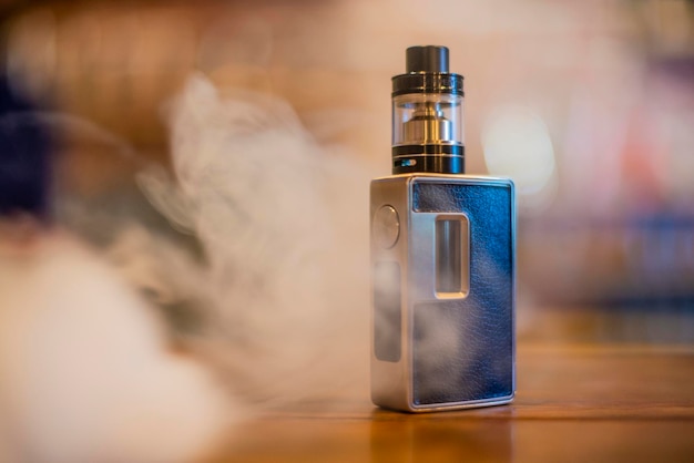 electronic cigarette on a background of vape shop. e-cigarette for vaping. popular vape devices