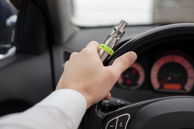 Photo electronic cigarette at the wheel.