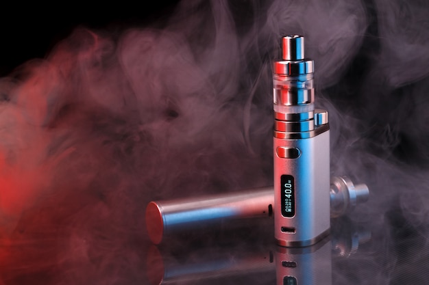 Photo electronic cigarette within vapor on black background