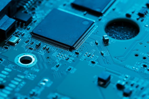 Electronic circuit board close up, processor, chips and capacitors.