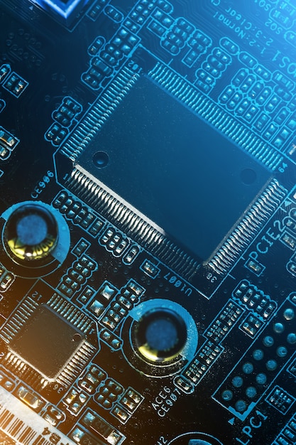 Electronic circuit board close up, processor, chips and capacitors.