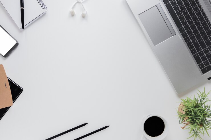 Photo electronic devices near stationery on white table