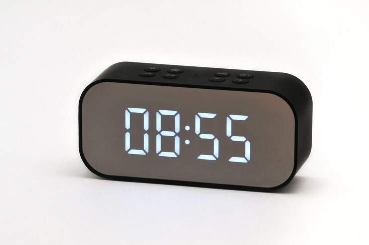 Electronic liquid crystal clock with digital indication of time and date on isolated white background
