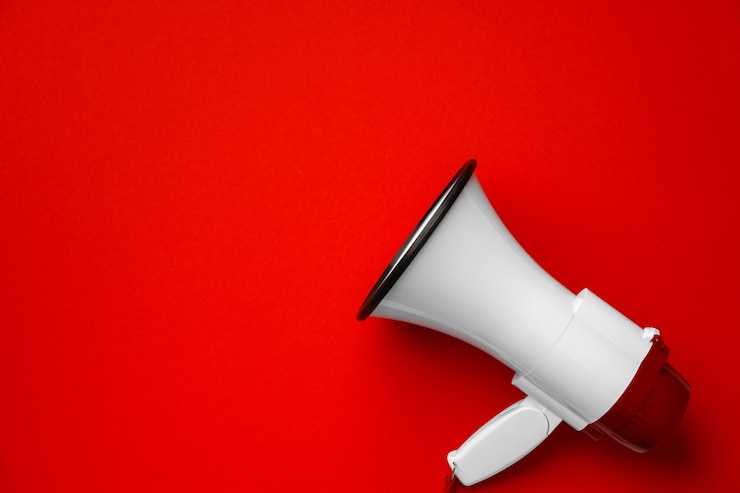 Photo electronic megaphone close up on red surface