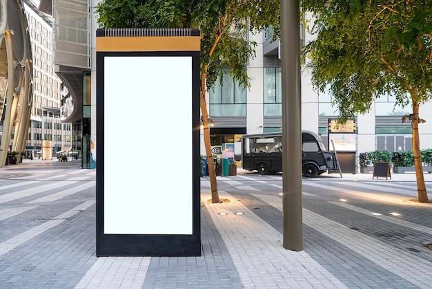 Electronic modern empty scoreboard on the background of a city street Blank mock up of vertical street poster billboard on city background