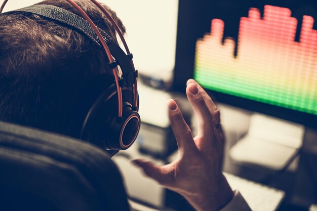 electronic music producer in headphones listening to his track