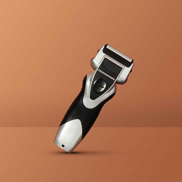 Photo electronic razor balancing with orange background