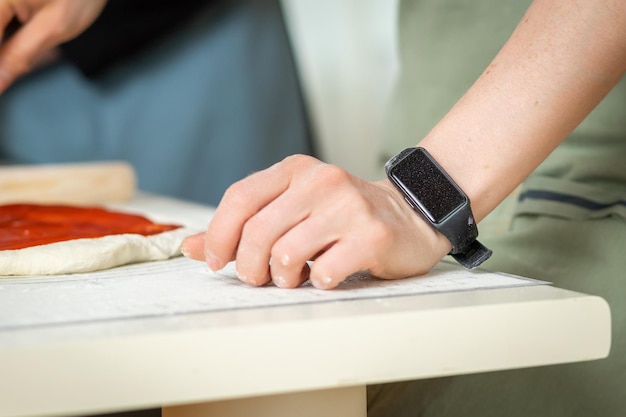 Electronic watch on the hand of a cook doing cooking in the kitchen