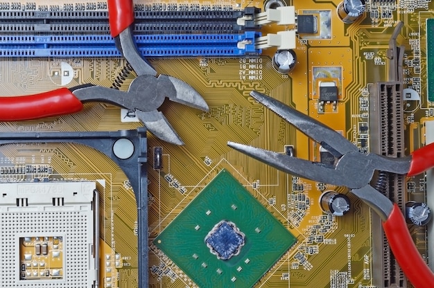 The electronics repair tool lies on the motherboard from the computer. close-up.