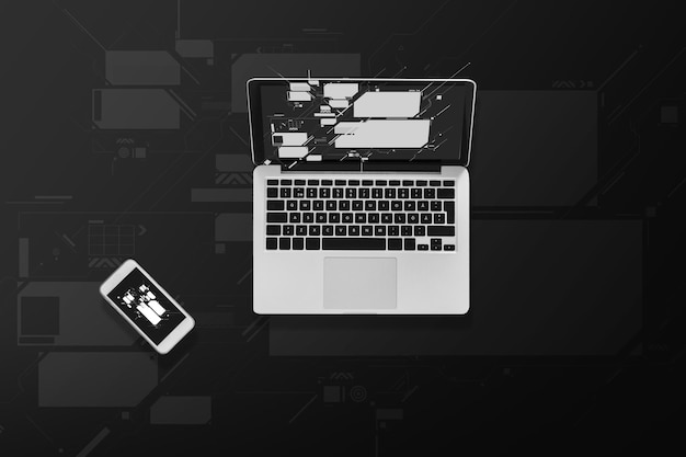 electronics and technology concept - laptop computer and smartphone top view
