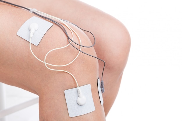 Electrostimulator massager treats knee trauma. Sports injuries.