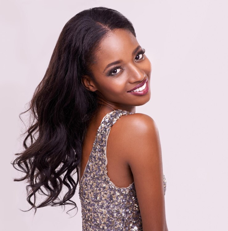Photo elegance comes naturally to her cropped studio portrait of a beautiful young woman on a pink background