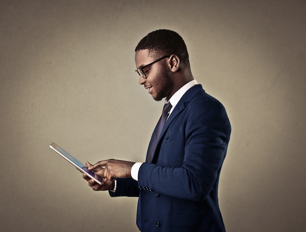 Elegant Afro man using a tablet