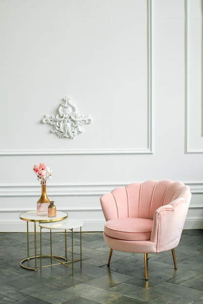 Elegant armchair and coffee table in minimalist livingroom interior