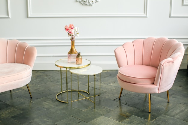 Elegant armchairs and coffee table in minimalist livingroom interior