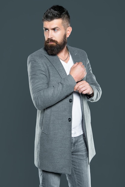 Elegant bearded mature man wear jacket on grey background