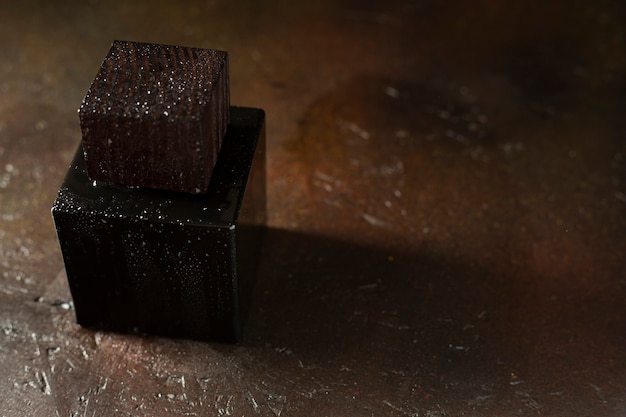 Elegant black perfume cap wooden on black background