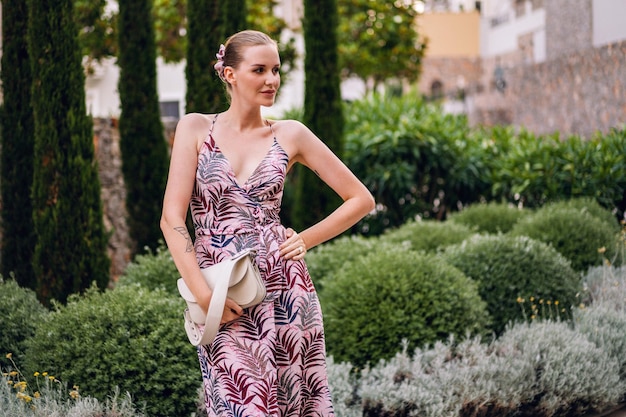 Elegant blonde woman enjoy her luxury vacation in Italy stylish summer dress