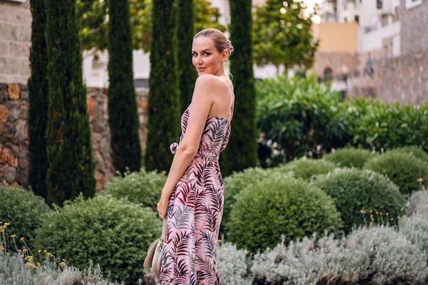 Elegant blonde woman enjoy her luxury vacation in Italy stylish summer dress