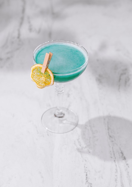 Elegant blue cocktail on marble surface