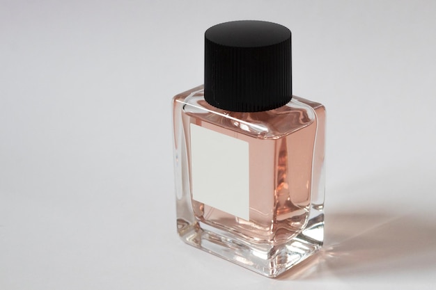 Elegant bottle of women's perfume close-up on an isolated background