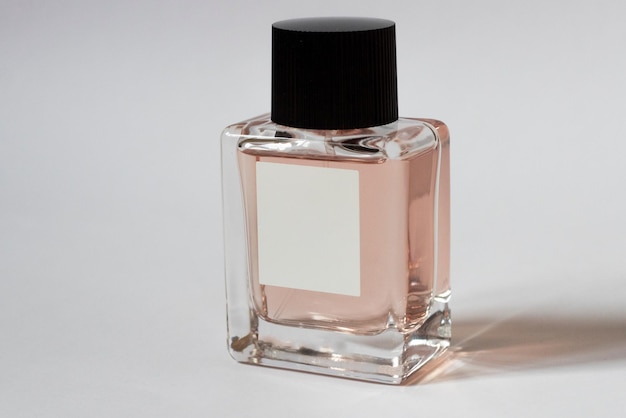 Elegant bottle of women's perfume close-up on an isolated background