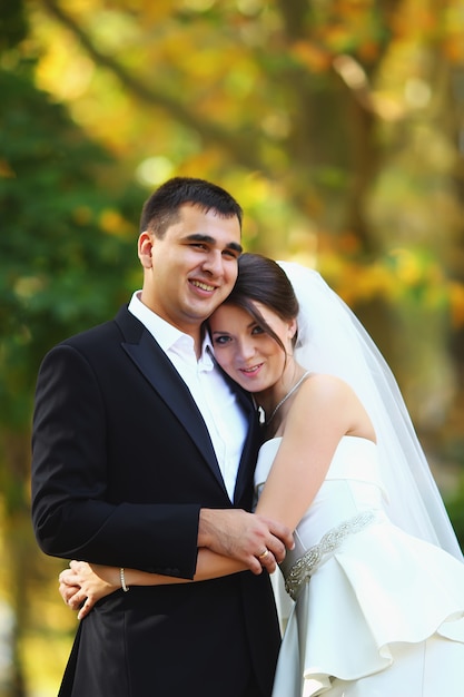 Elegant bride and groom posing together outdoors on a wedding day