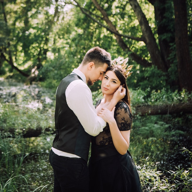 Elegant bride and groom posing together outdoors on a wedding day