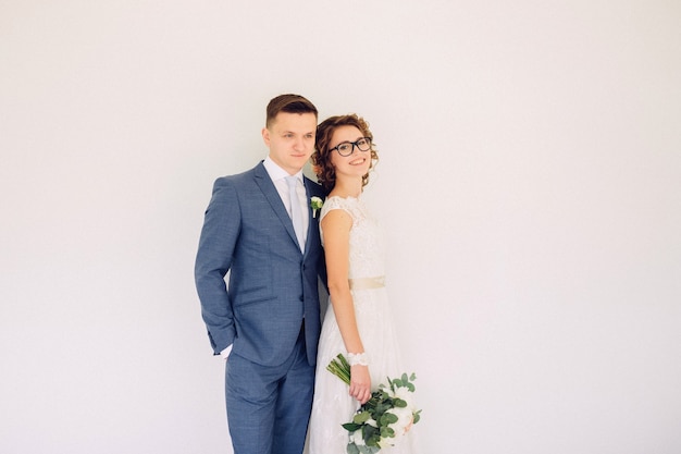 Elegant bride and groom posing together outdoors on a wedding day