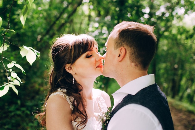 Elegant bride and groom posing together outdoors on a wedding day