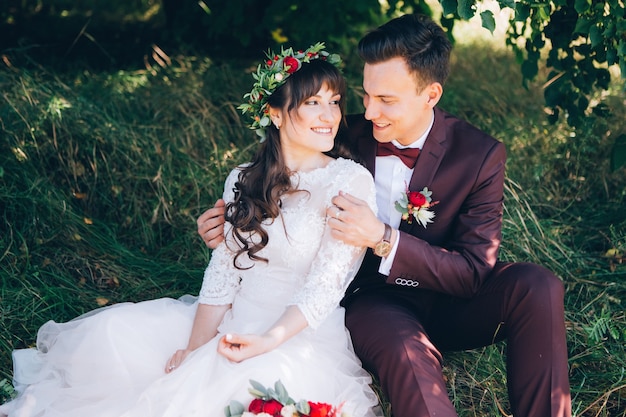 Elegant bride and groom posing together outdoors on a wedding day