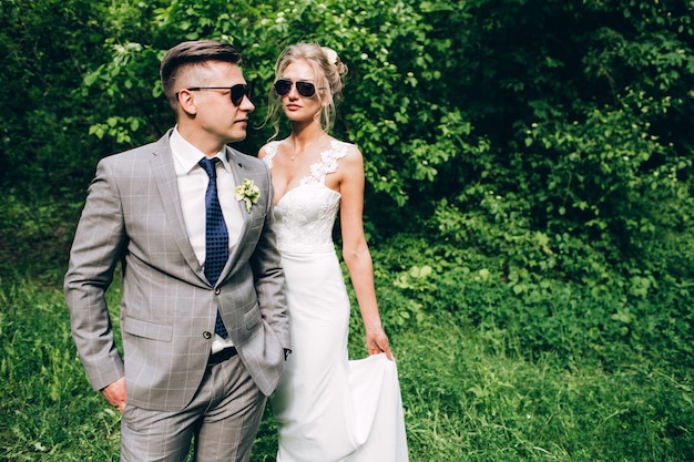 Elegant bride and groom posing together outdoors on a wedding day