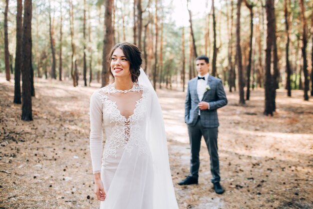 Elegant bride and groom posing together outdoors on a wedding day