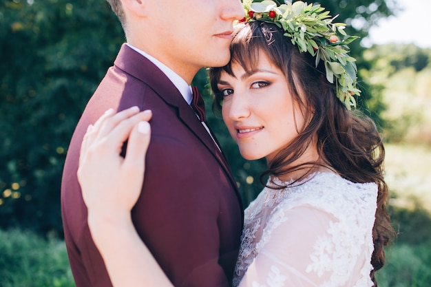 Elegant bride and groom posing together outdoors on a wedding day