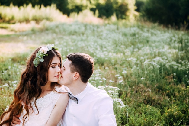 Elegant bride and groom posing together outdoors on a wedding day