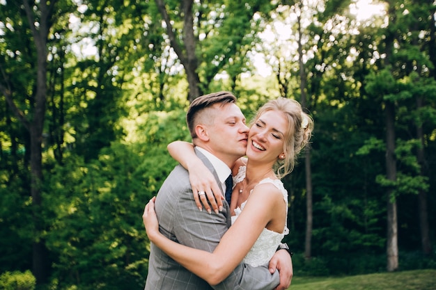 Elegant bride and groom posing together outdoors on a wedding day